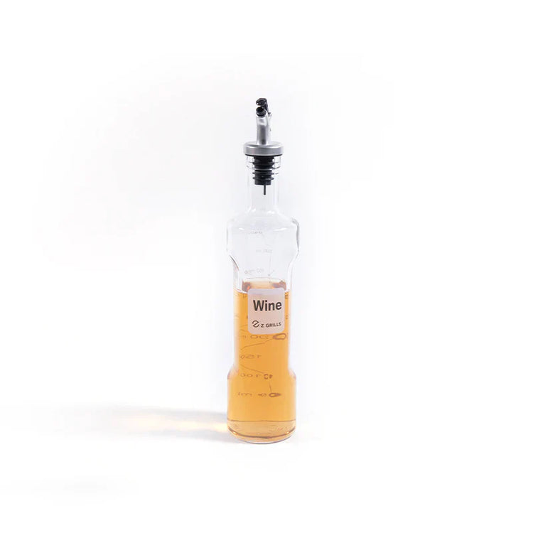 Clear wine bottle with a black cap on a white background