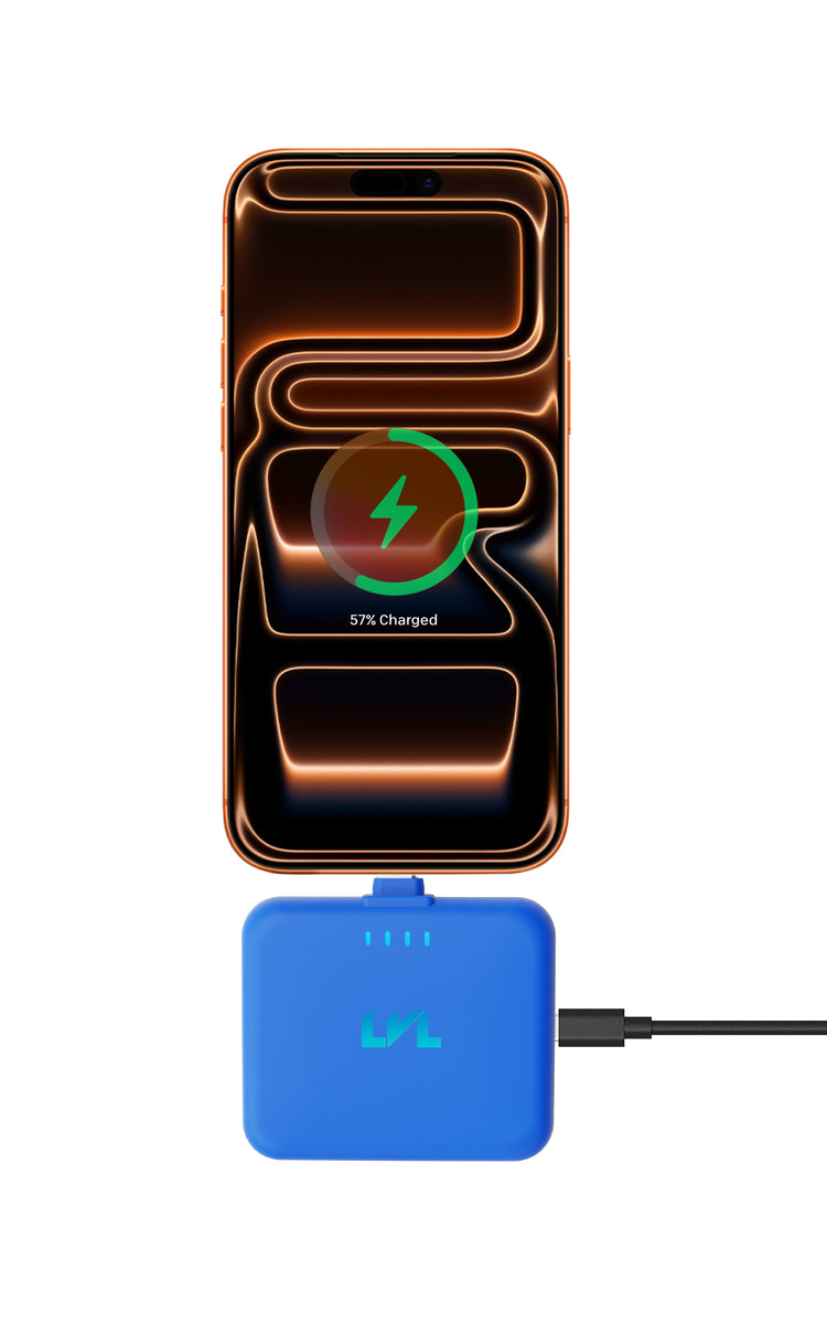Smartphone with wireless charging pad and blue cable on a white background