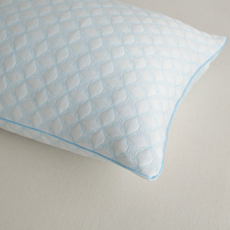 Blue textured pillow on a neutral background