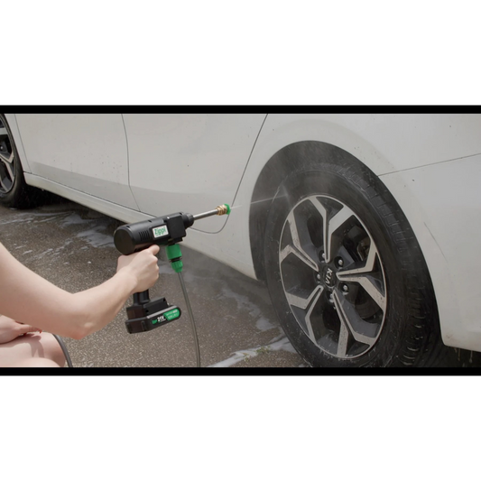 A Zippi Hydro Cleaner Deluxe with a black color scheme, including a gun handle, hose, nozzles, a carrying case, and other accessories.