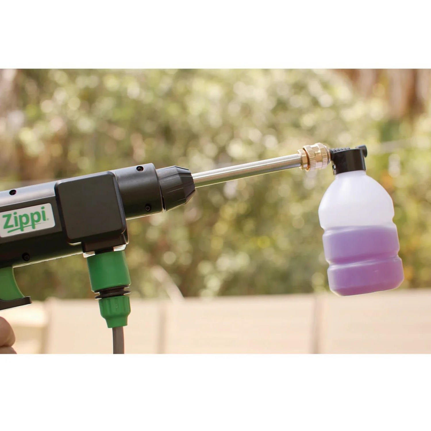 Zippi airbrush gun with a small container attached, outdoors.
