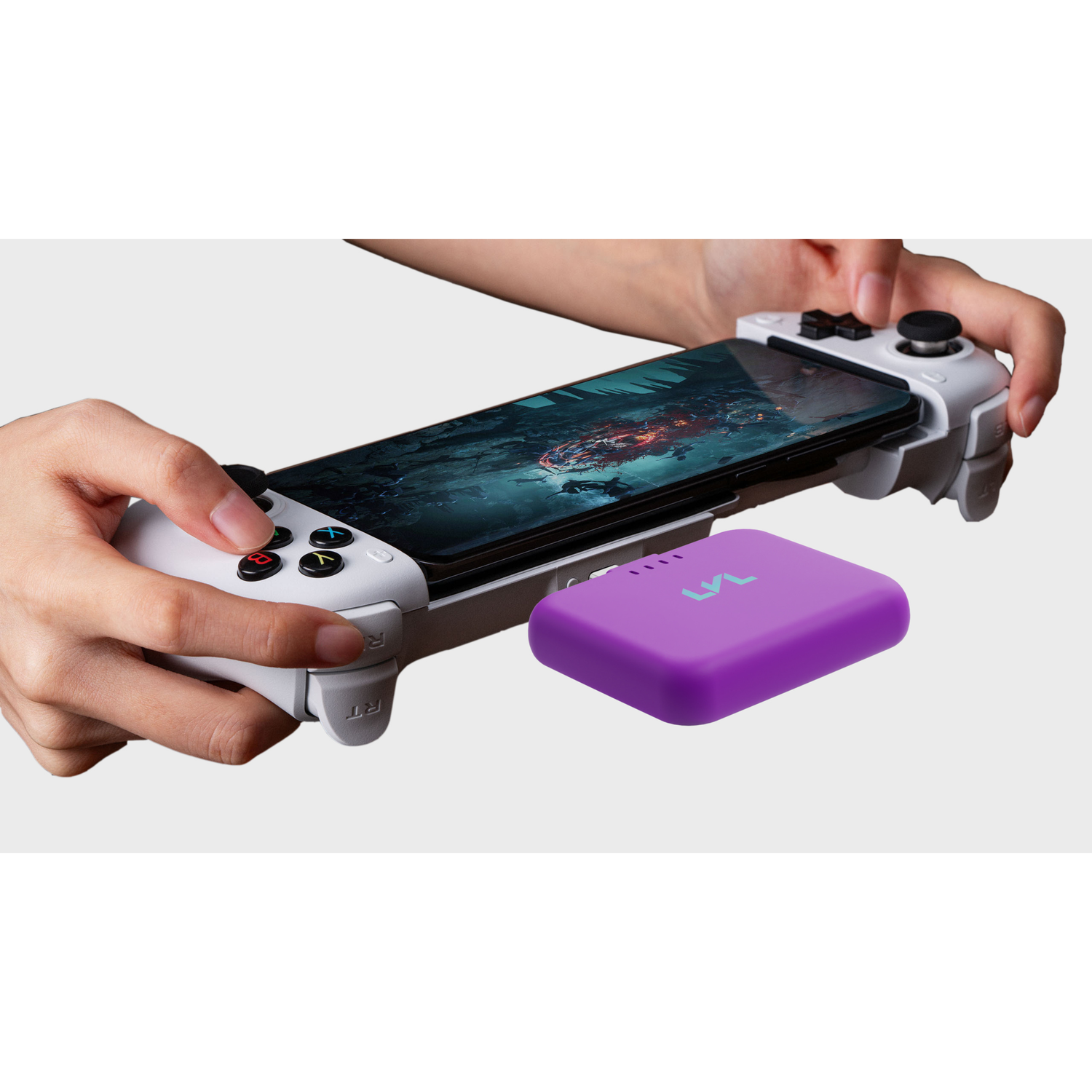 Hand holding a smartphone with a gaming controller attached, next to a purple device on a white background