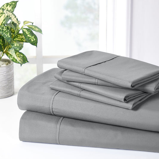 A charcoal grey 6 piece bamboo sheet set displayed on a bed, including a fitted sheet, a flat sheet, and pillow covers with a second pillow placed on the bed.