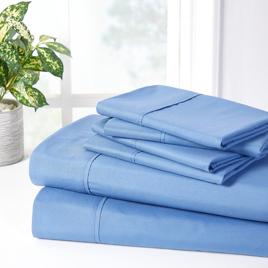 A set of ocean blue bamboo sheets displayed on a bed, including a fitted sheet, a flat sheet, and pillowcases.