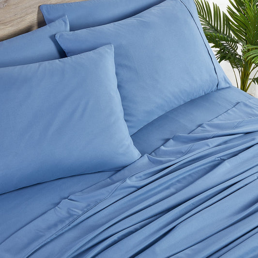 A set of ocean blue bamboo sheets displayed on a bed, including a fitted sheet, a flat sheet, and pillowcases.