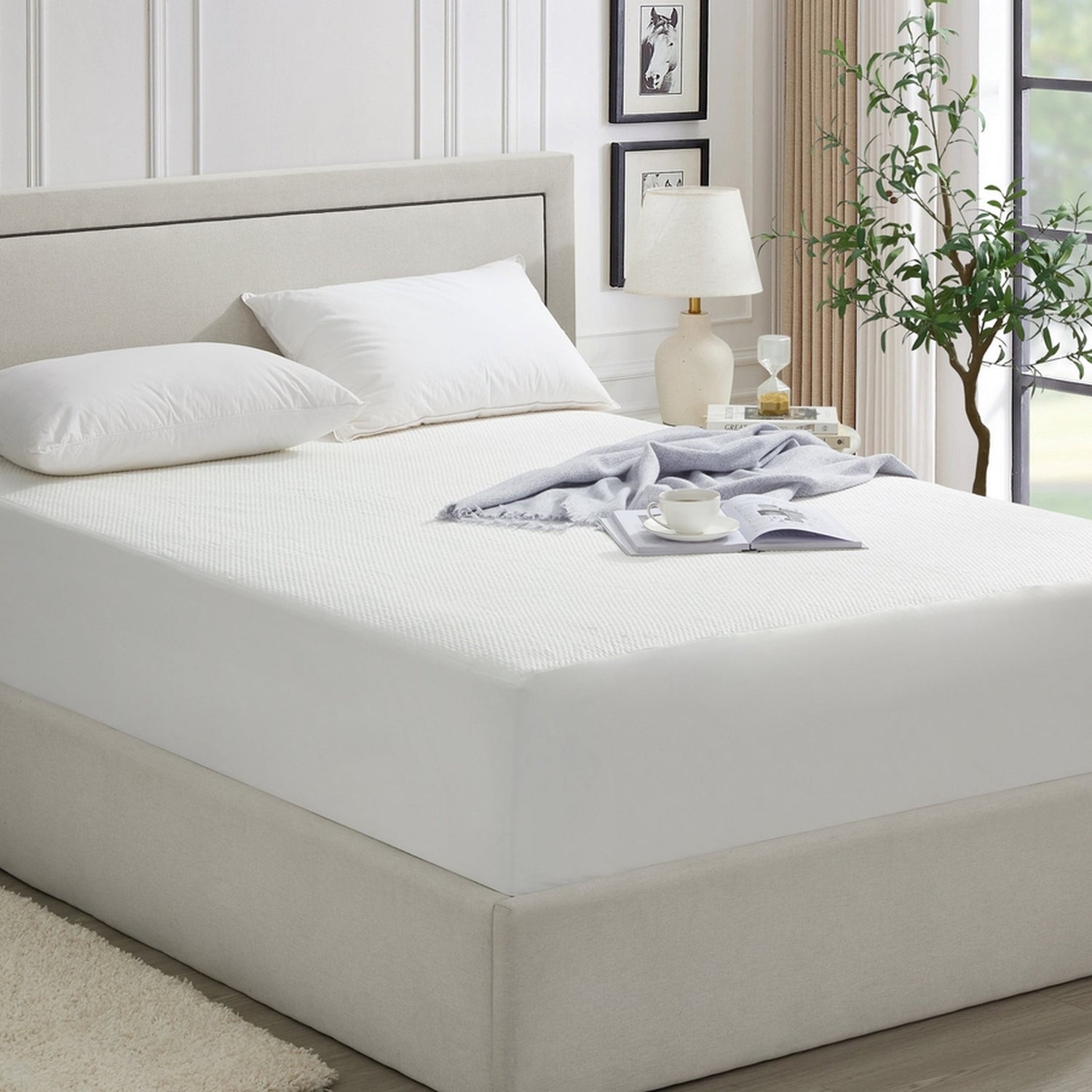 Bed with white bedding and a nightstand in a bedroom setting