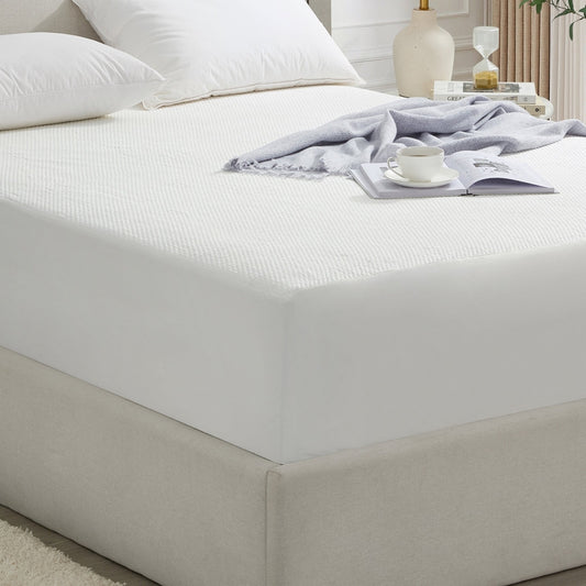 Bed with white bedding and a nightstand in a bedroom setting
