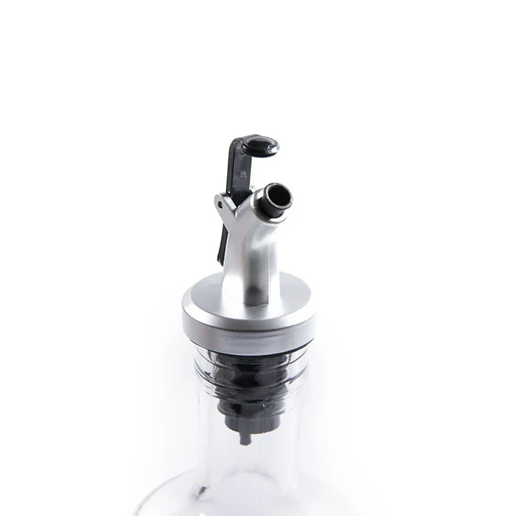 Clear glass bottle with a metal cap on a white background