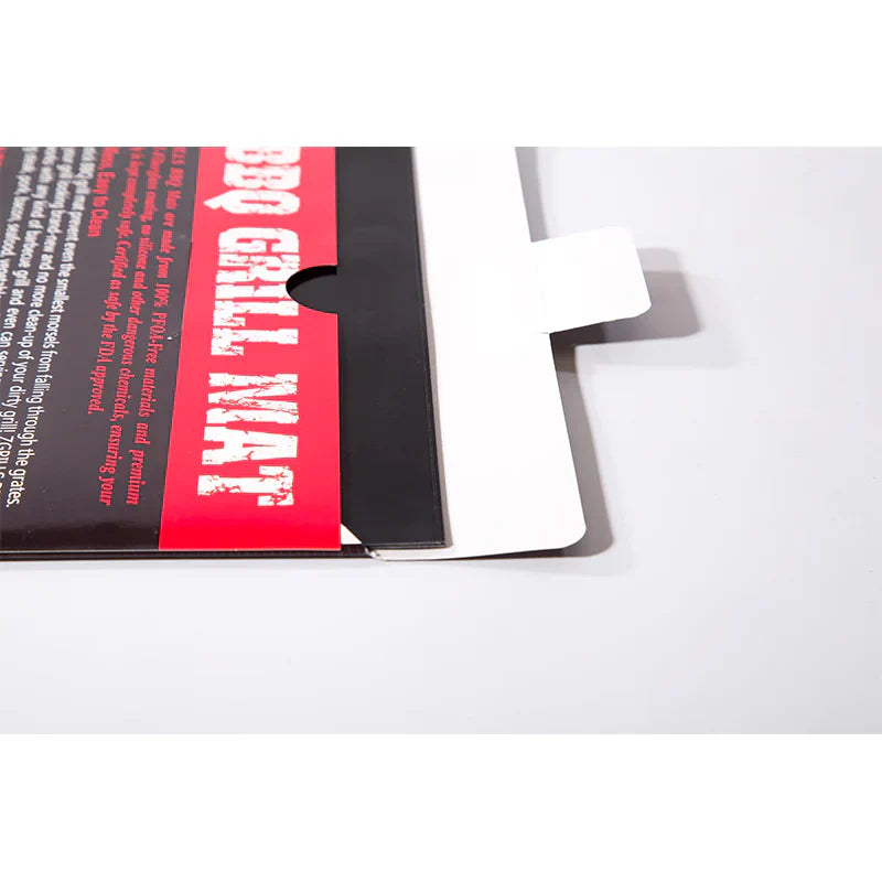 Close-up of a book with a red and black cover on a white background