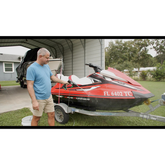 A Zippi Hydro Cleaner Deluxe with a black color scheme, including a gun handle, hose, nozzles, a carrying case, and other accessories.