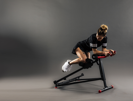 Black and red exercise machine on a gray background