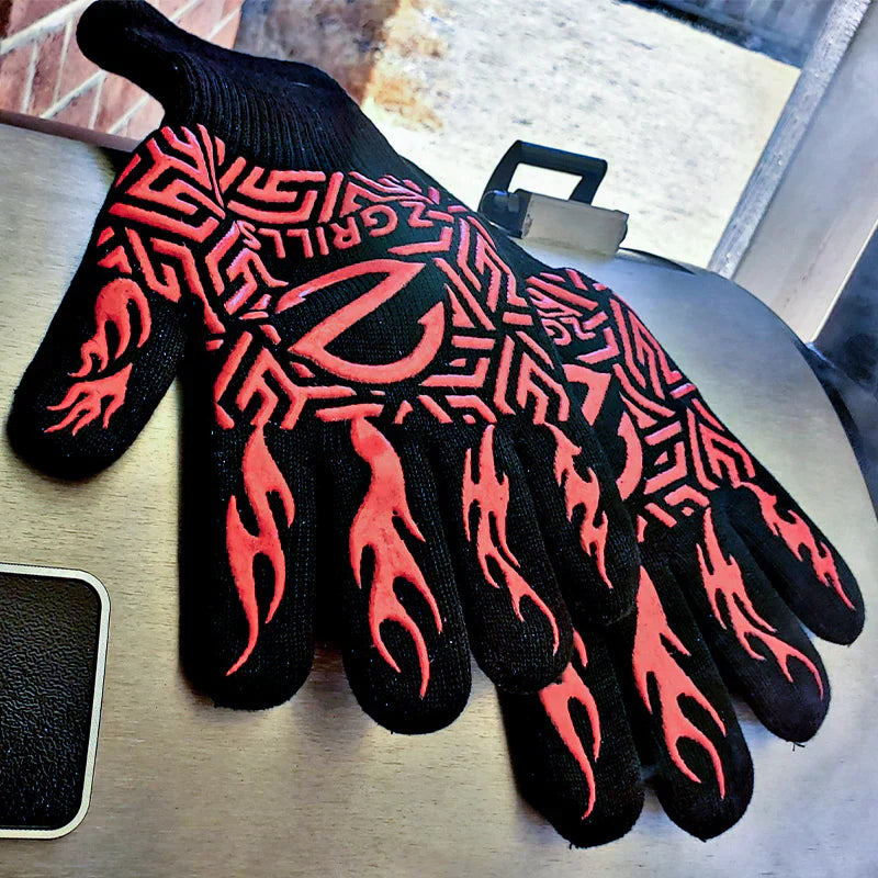 Black gloves with red flame patterns on a metal surface