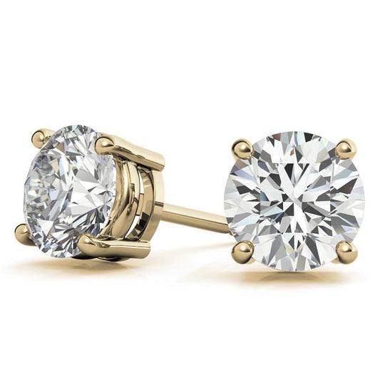 Gold stud earrings with round diamonds on a white background