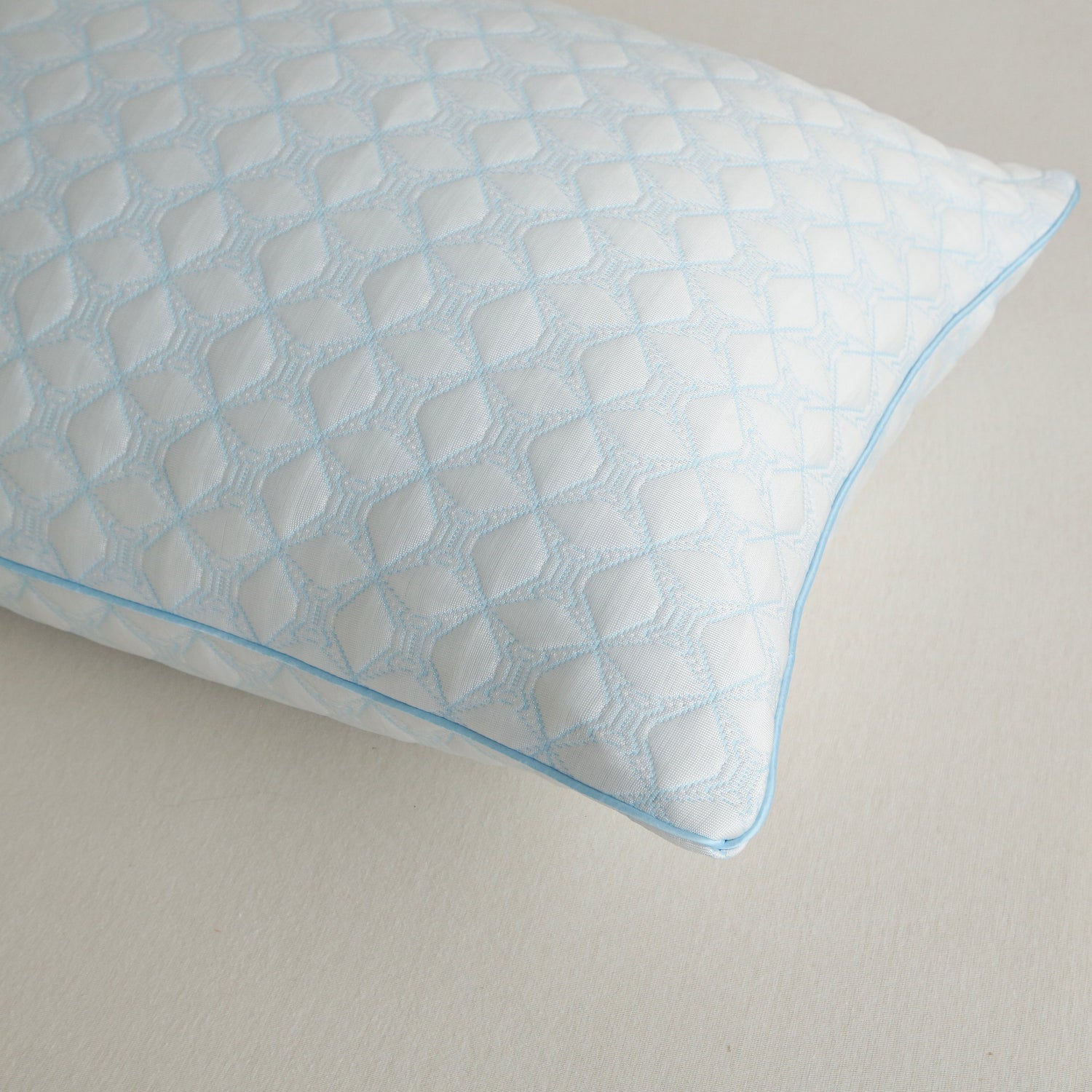 Blue textured pillow on a neutral background