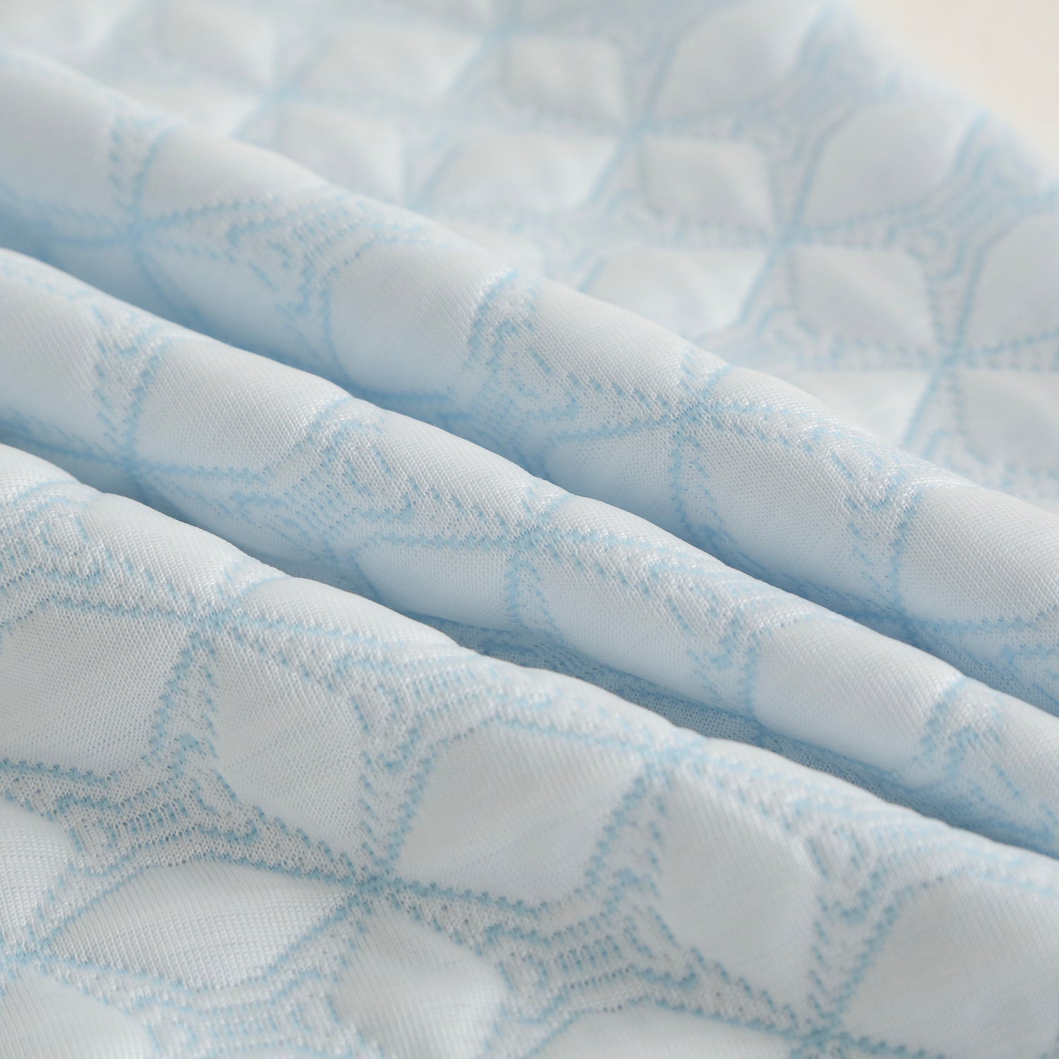 Close-up of a textured blue and white fabric with a geometric pattern