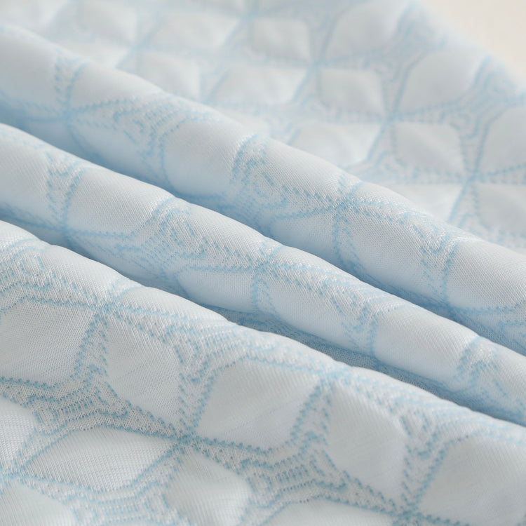 Close-up of a textured blue and white fabric with a geometric pattern