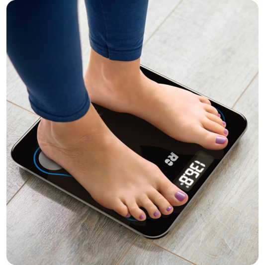 A black digital smart scale with blue decorative elements and silver brand logos, displaying a weight reading.
