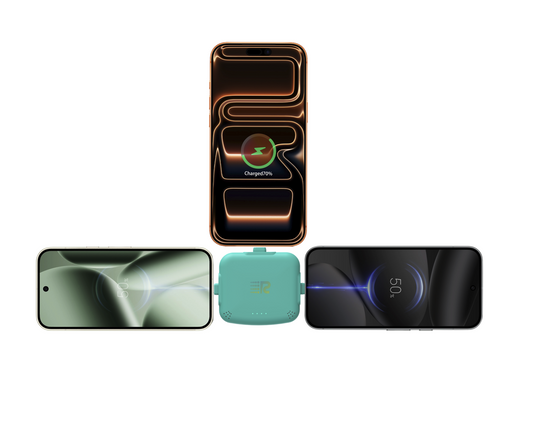 Four small electronic trackers in different colors (gray, mint green, pink, and white) lined up in a row against a plain white background.